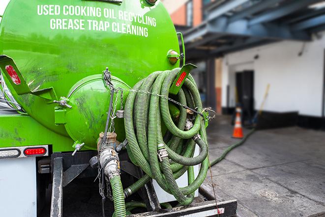 large truck pumping grease trap at a restaurant in Antelope